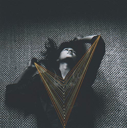 Woman with outstretched arms framed by a golden geometric shape.