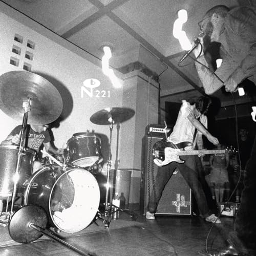 Black and white photo of a band performing live on stage.