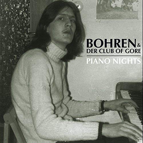 Black and white album cover featuring a man at a piano.