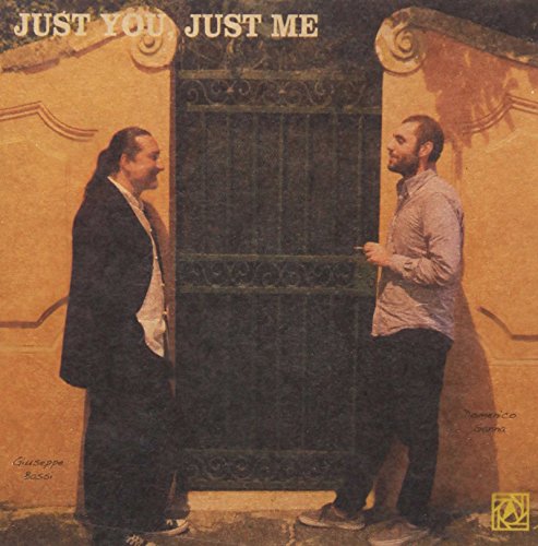 CD cover: two men stand near an ornate, dark doorway.