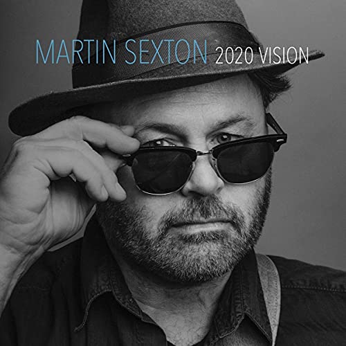 Black and white portrait of Martin Sexton wearing a hat and sunglasses.