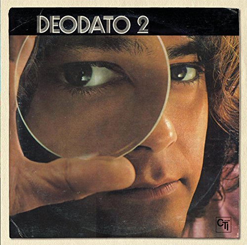Album cover showing a person looking through a magnifying glass held over their eye.