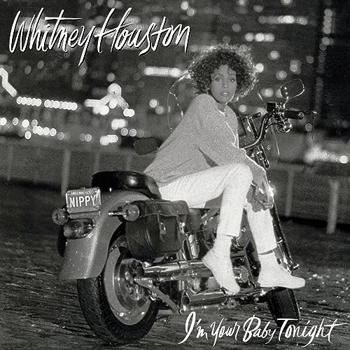 Whitney Houston seated on a motorcycle, album cover for “I’m Your Baby Tonight.”