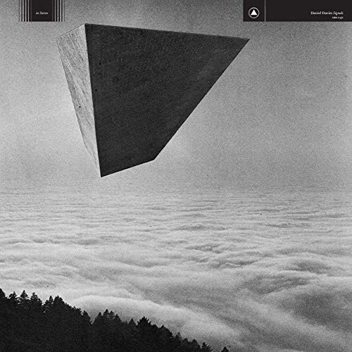 Black and white album cover with a floating triangular prism over clouds.