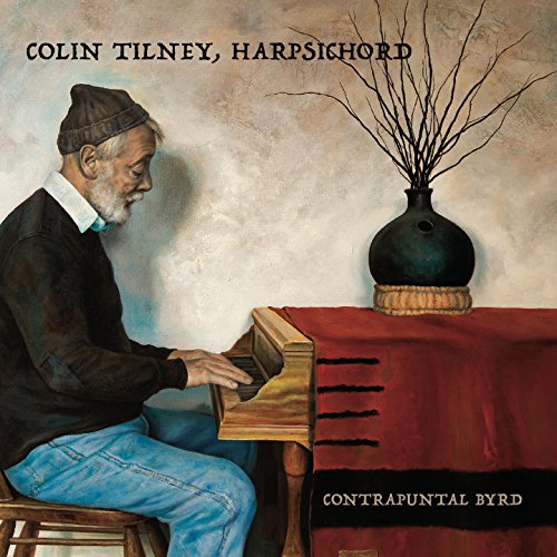 Man playing harpsichord with a vase of branches on a red cloth.