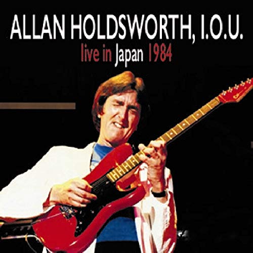 Allan Holdsworth playing a red electric guitar on album cover.