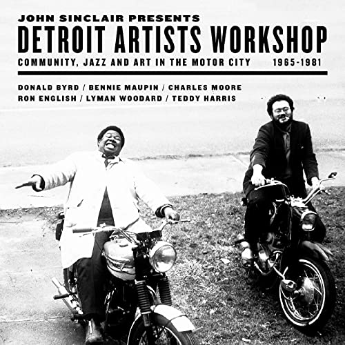Vinyl album cover featuring two men with a motorcycle, black and white photo.