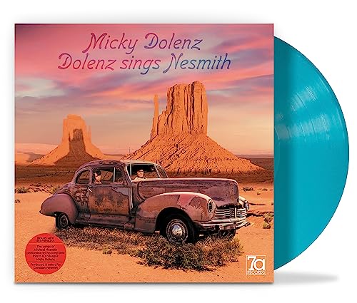 Vinyl record cover featuring desert landscape, car, and turquoise colored disc edge.