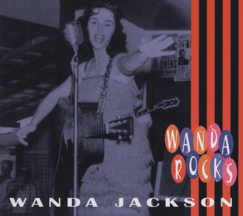 Black and white photo of Wanda Jackson singing into a microphone.