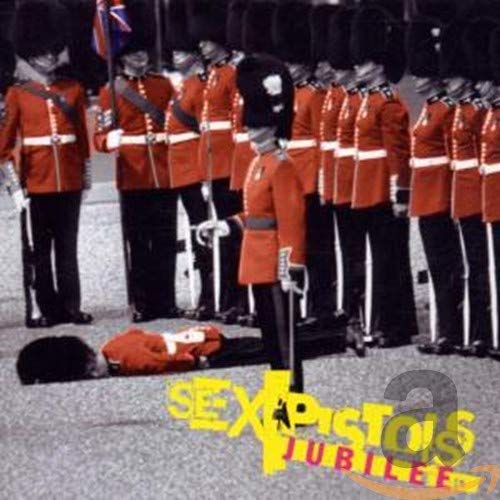 A line of British guards in red tunics with one guard lying on the ground.
