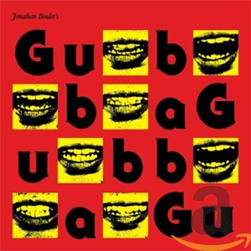 Red album cover with repeating images of smiling mouths and bold text.