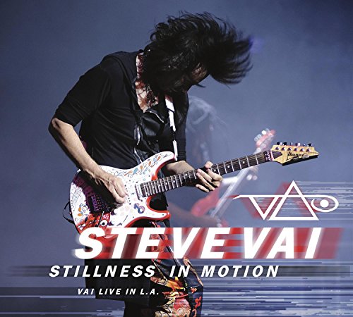 Steve Vai playing a colorful guitar on stage, album cover.