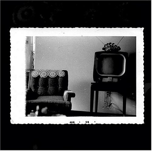 Vintage black and white photo of a room with a television set.
