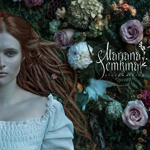 Red-haired woman surrounded by flowers and foliage, album cover art.