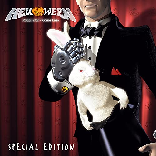 CD cover: Man in tuxedo holds robotic hand with white rabbit.