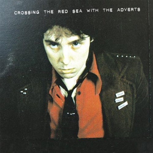 Album cover for "Crossing The Red Sea With The Adverts" featuring a young man.