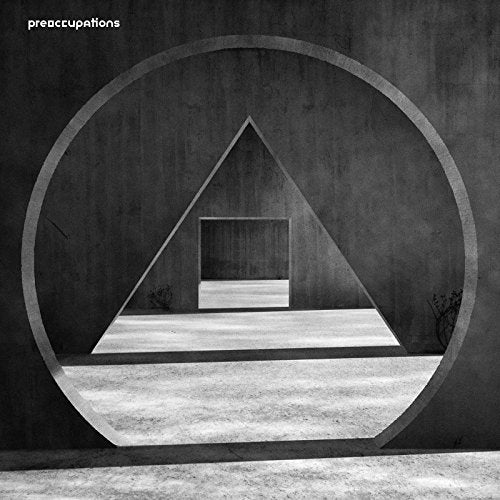 Album cover for Preoccupationsā āNew Materialā featuring geometric shapes.