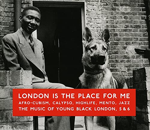 CD cover: man with dog in front of brick building.