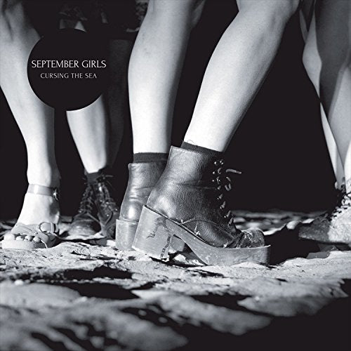 Black and white album cover showing legs and feet on a textured surface.
