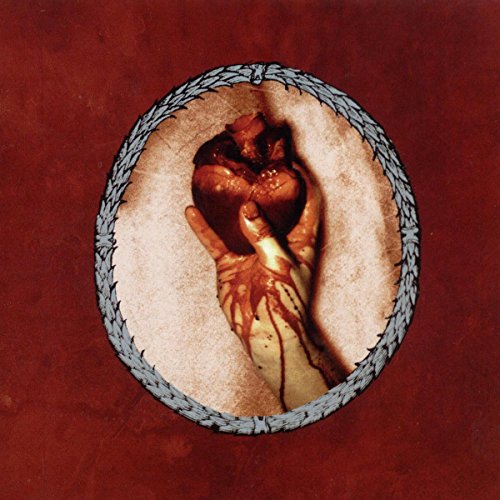 Hand holding a bleeding heart within a barbed wire oval frame.