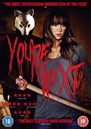 A woman holds an axe while a person in a fox mask stands behind her.