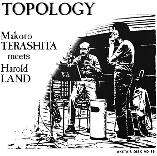 Black and white CD cover featuring two musicians and musical equipment.
