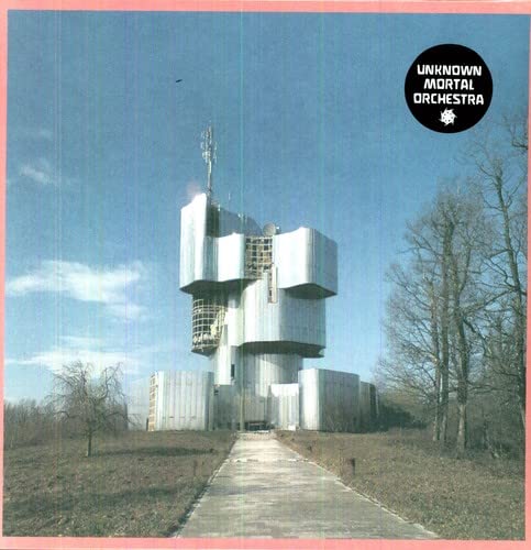 Vinyl album cover with a brutalist concrete tower against a blue sky.