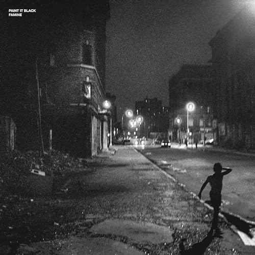 Black and white album cover depicting a dimly lit city street scene.