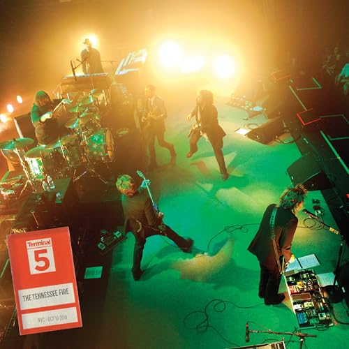 My Morning Jacket performing live on stage with bright stage lighting.