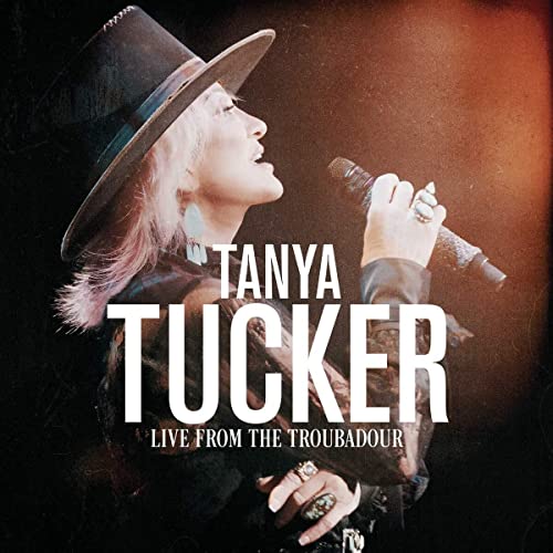 Tanya Tucker in a hat singing into a microphone, album cover.