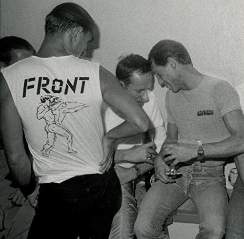 Black and white photo of men, one with "FRONT" printed on his back.