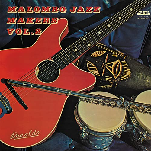 Album cover featuring a red guitar, drums, mask, and flute.