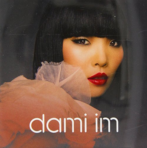 Close-up portrait of Dami Im with red lips, album cover art.