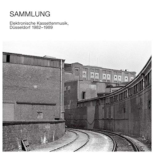 CD cover: Black and white photo of industrial buildings and railway tracks.