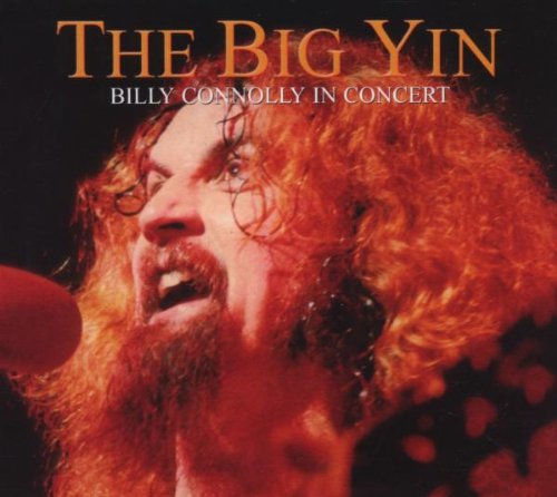 Billy Connolly with red hair and beard, performing on stage.