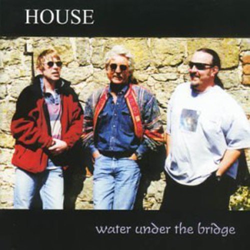 CD cover: three men in sunglasses stand against a stone wall.