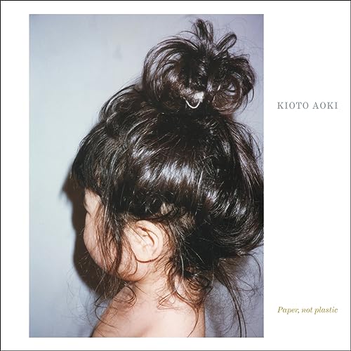 CD cover featuring a person's head from behind with hair in a bun.