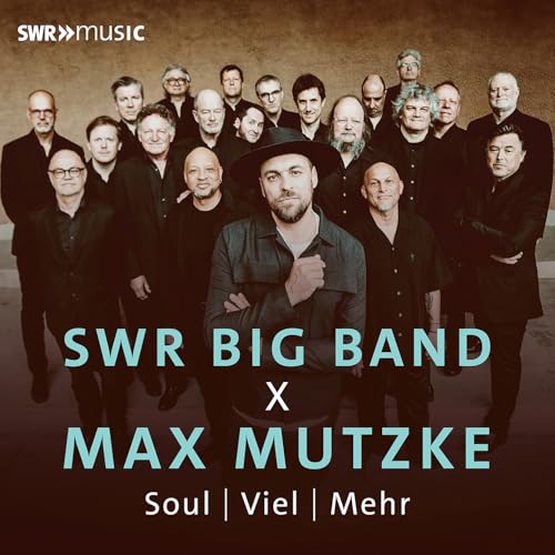 Max Mutzke and the SWR Big Band posing in dark attire.