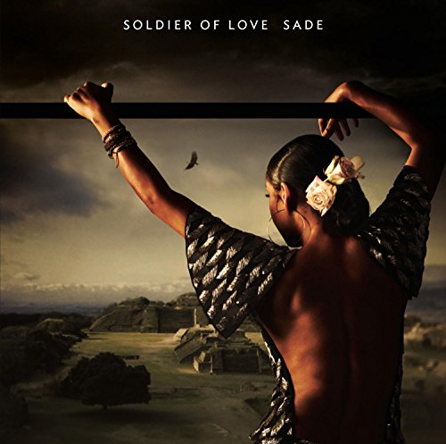 Sade album cover: woman with arms raised, landscape, and a bird.
