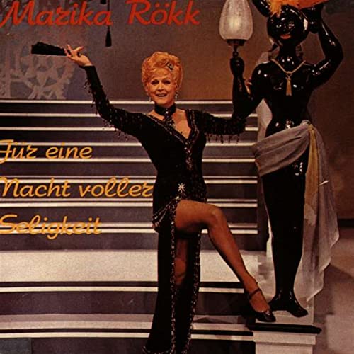 CD cover featuring Marika Rökk in a black dress and a costumed performer.
