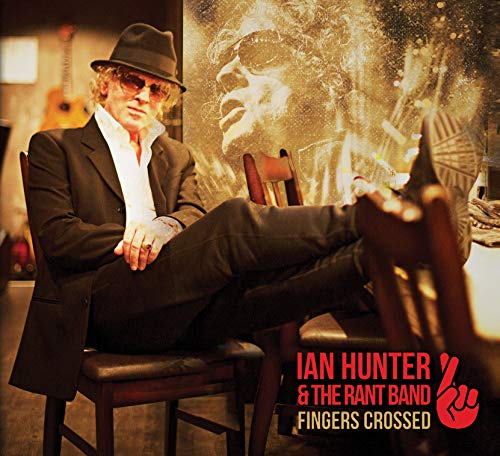 Ian Hunter in a suit and hat, legs crossed, album cover.