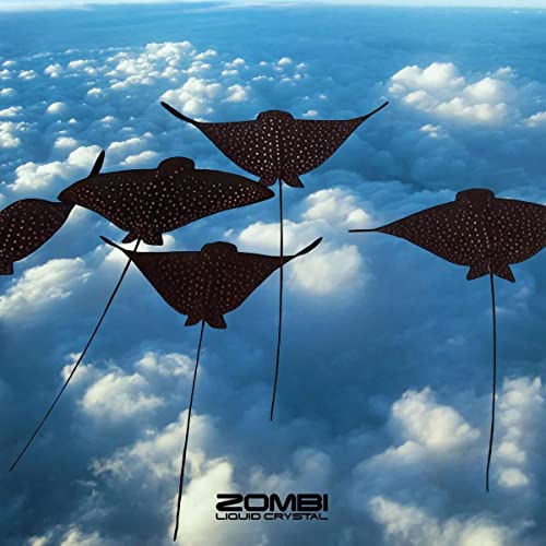 Five spotted stingrays floating in a blue sky filled with white clouds.