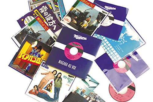 Various Japanese 45s and 7-inch vinyl records in colorful sleeves.