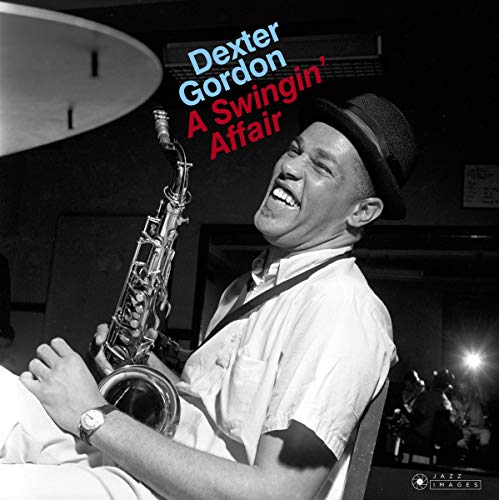 Black and white portrait of Dexter Gordon with saxophone, smiling.