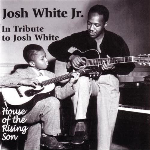 Josh White Jr. with a young boy, both playing acoustic guitars.