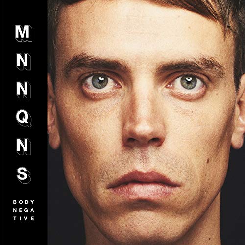 Close-up portrait of a young man with the album title vertically aligned.