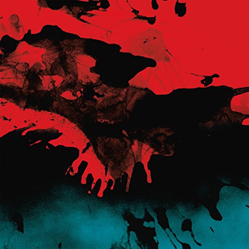 Abstract red and black paint splatters on a dark teal background.