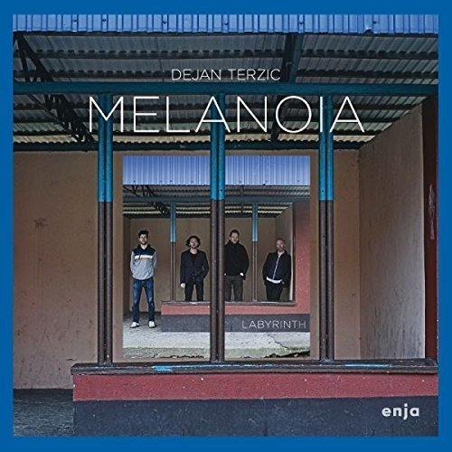 CD cover: four men stand behind a metal and glass structure.