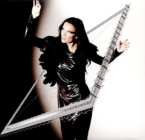 Tarja Turunen in black, posing with a geometric, reflective shape.