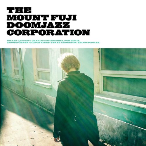 CD cover: person with blonde hair seen from behind, teal building.